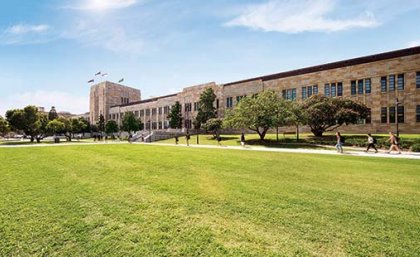 UQ's Forgan Smith building with green lawn in the foreground.